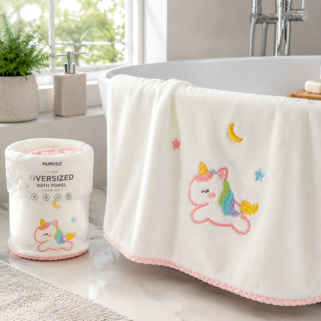 Weißes MUMUSO Oversize-Badetuch der Einhorn-Serie an einer Badewanne